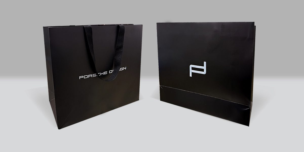 Porsche Design black shopping bags with rope handles, front and back, by VSL Packaging